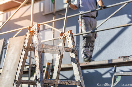 Image of Modern house under construction with scaffold pole platform. 