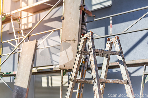 Image of Modern house under construction with scaffold pole platform. 