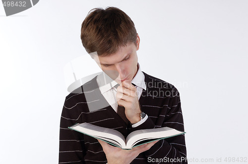 Image of Young man reading a book