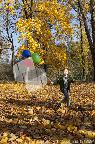 Image of red-haired boy in autumn park