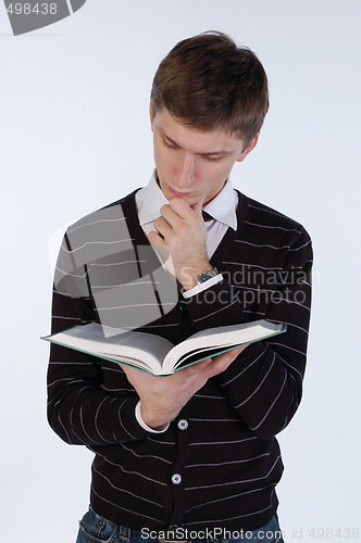 Image of Young man reading a book