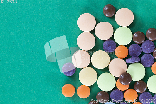 Image of Multi-colored pills on a green background