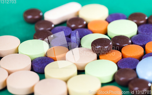 Image of Multi-colored pills on a green background