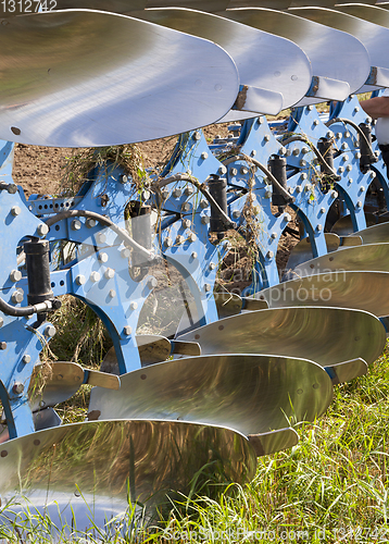 Image of blue steel plows during tillage, field Agricultural.