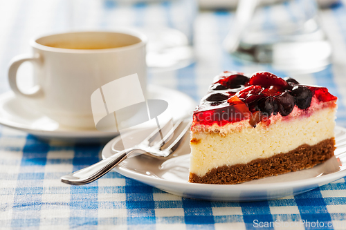 Image of Cake on plate with fork and coffee cup