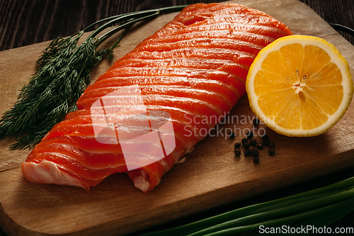 Image of Fresh salmon piece on wooden board