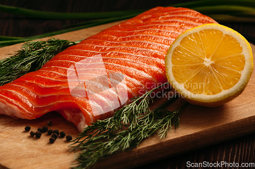 Image of Fresh salmon piece on wooden board