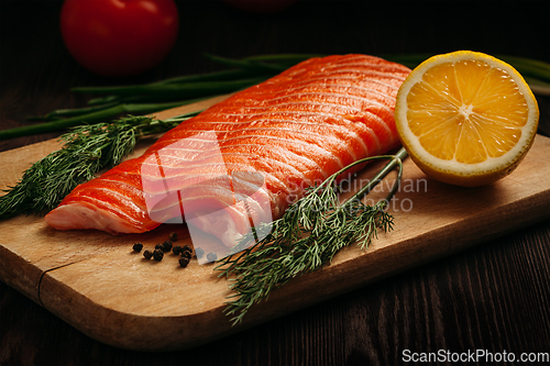 Image of Fresh salmon piece on wooden board