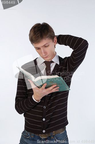 Image of Young man reading a book