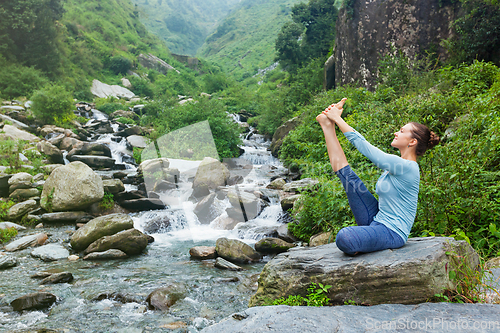 Image of Woman doing Ashtanga Vinyasa Yoga asana outdoors