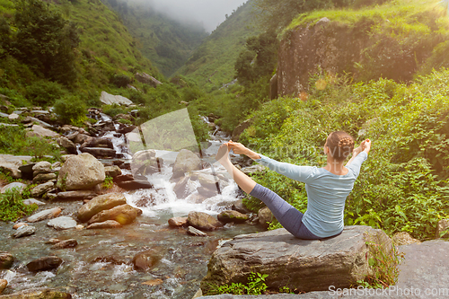 Image of Woman doing Ashtanga Vinyasa Yoga asana outdoors