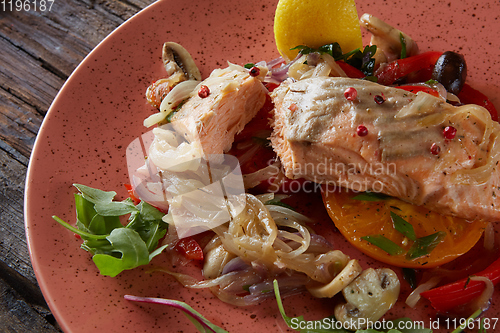 Image of Steamed salmon with vegetables on a plate.