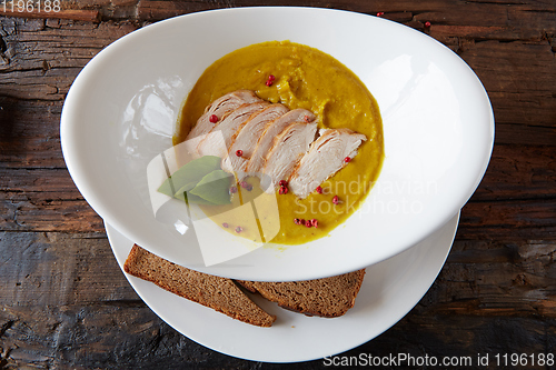Image of Pumpkin and carrot soup with chicken. Top view. Copy space.