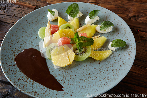 Image of Bowl of healthy fresh fruit salad fruit with chocolate