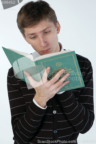 Image of Young man reading a book