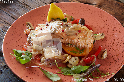 Image of Steamed salmon with vegetables on a plate.