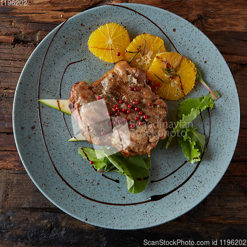 Image of Chicken Steak with oranges and greens. Shallow dof.