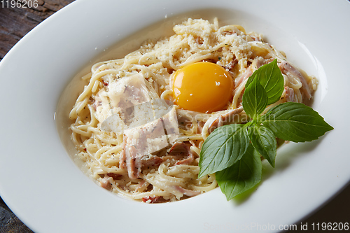 Image of Pasta Carbonara on white plate with parmesan