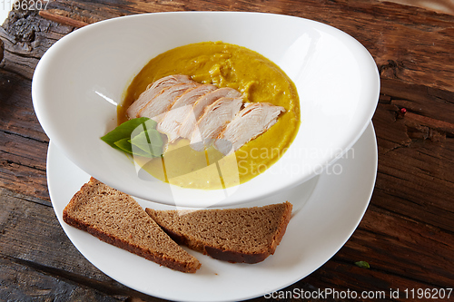 Image of Pumpkin and carrot soup with chicken. Top view. Copy space.