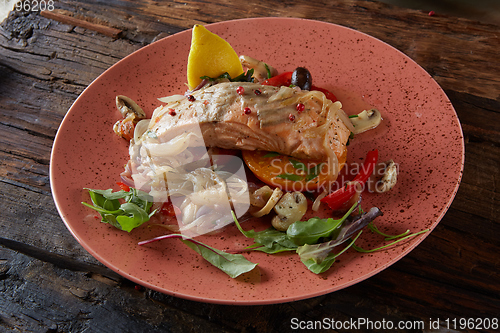 Image of Steamed salmon with vegetables on a plate.