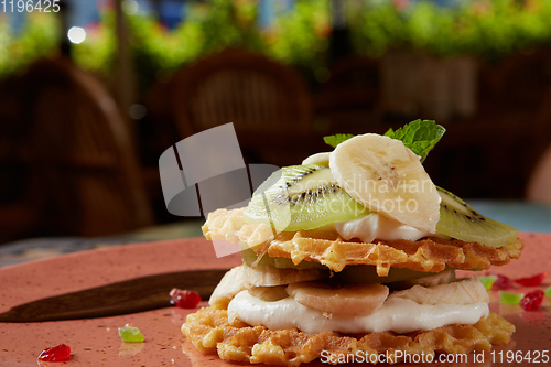 Image of Fresh waffles with ice cream and maple syrup.