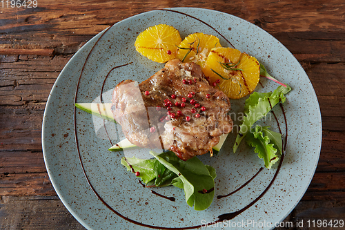 Image of Chicken Steak with oranges and greens. Shallow dof.