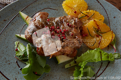 Image of Chicken Steak with oranges and greens. Shallow dof.