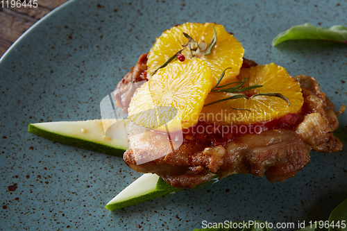 Image of Chicken Steak with oranges and greens. Shallow dof.