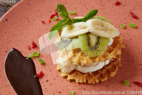 Image of Fresh waffles with ice cream and maple syrup.