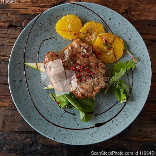 Image of Chicken Steak with oranges and greens. Shallow dof.