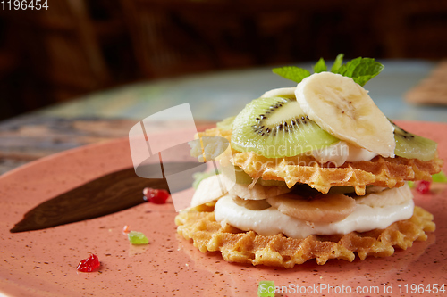 Image of Fresh waffles with ice cream and maple syrup.