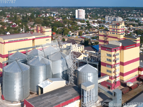 Image of Agricultural Silo. Storage and drying of grains, wheat, corn, soy, against the blue sky with clouds.