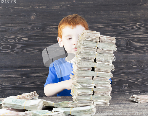 Image of Boy and money tower