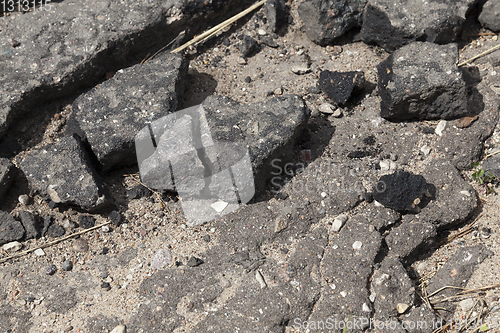 Image of destruction asphalt road piece