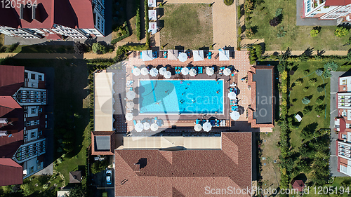 Image of Aerial view on people in swimming pool. Top view of people sunbathing pool.