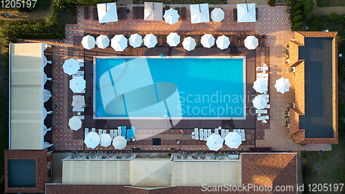 Image of Aerial view on people in swimming pool. Top view of people sunbathing pool.