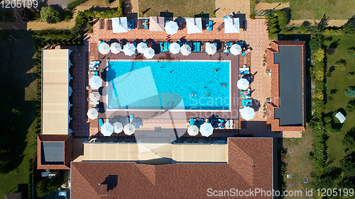 Image of Aerial view on people in swimming pool. Top view of people sunbathing pool.