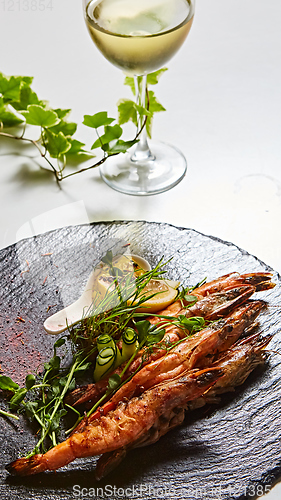 Image of Grilled shrimp skewers. Seafood, shelfish. Shrimps Prawns skewers with herbs, garlic and lemon.