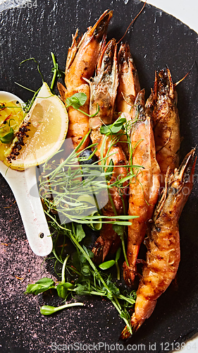 Image of Grilled shrimp skewers. Seafood, shelfish. Shrimps Prawns skewers with herbs, garlic and lemon.