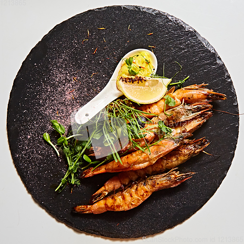 Image of Grilled shrimp skewers. Seafood, shelfish. Shrimps Prawns skewers with herbs, garlic and lemon.