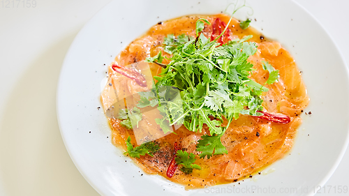 Image of Top view of salmon carpaccio. Shallow dof.