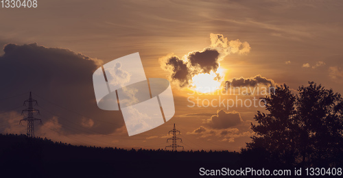 Image of summer sunset with electricity tower