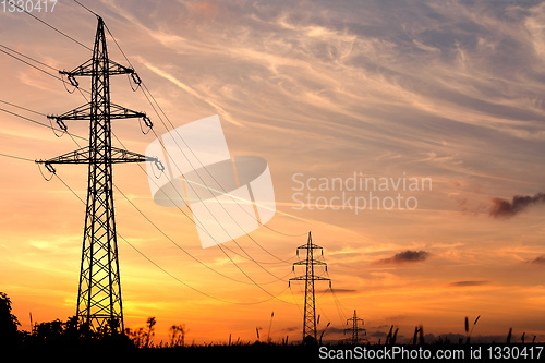 Image of summer sunset with electricity tower
