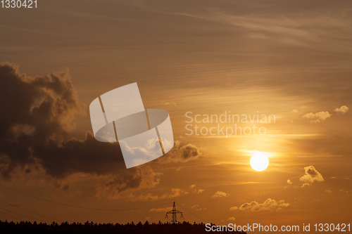 Image of summer sunset with electricity tower