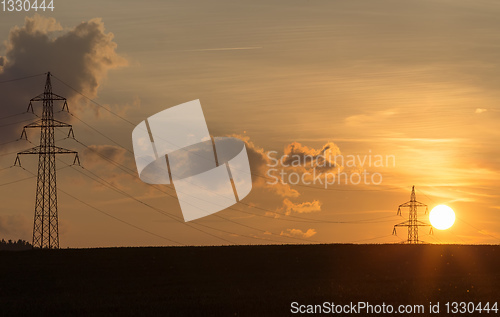 Image of summer sunset with electricity tower