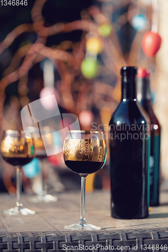 Image of Bottle of vine, glass and easter eggs