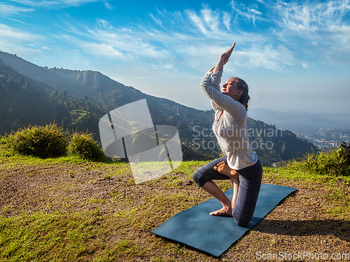 Image of Woman doing Ashtanga Vinyasa yoga advanced asana