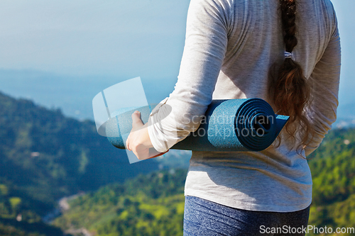 Image of Woman standing with yoga