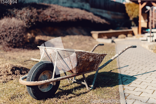 Image of old rusty garden wheelbarrow