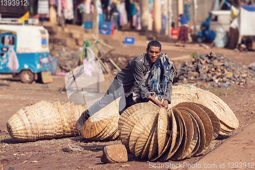 Image of Ethiopian man sells wicker baskets on the street